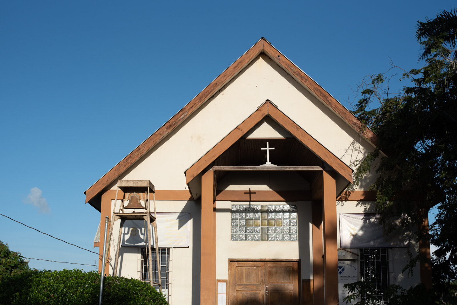 small church building with a cross over the front entrance