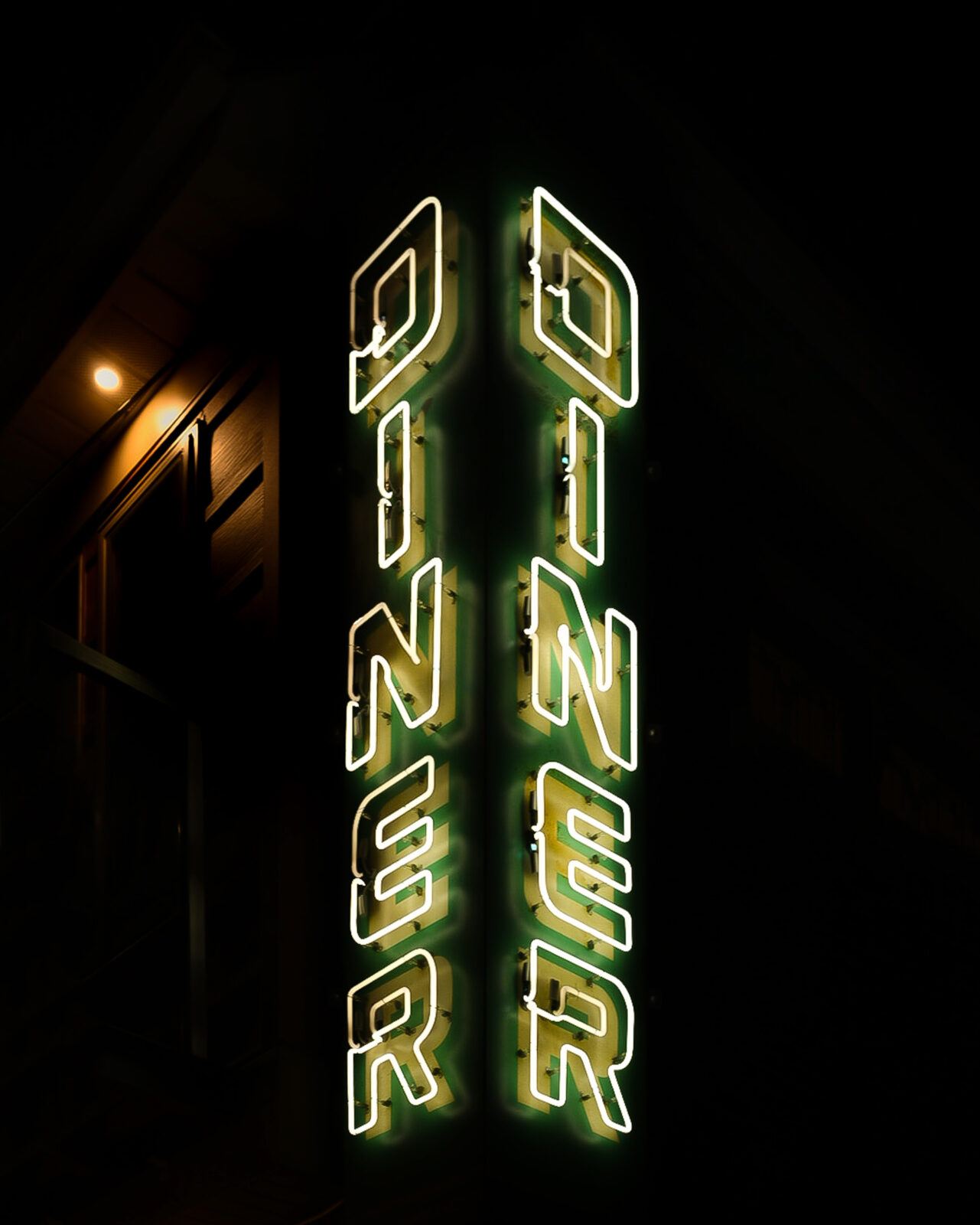 corner neon sign with the word 
